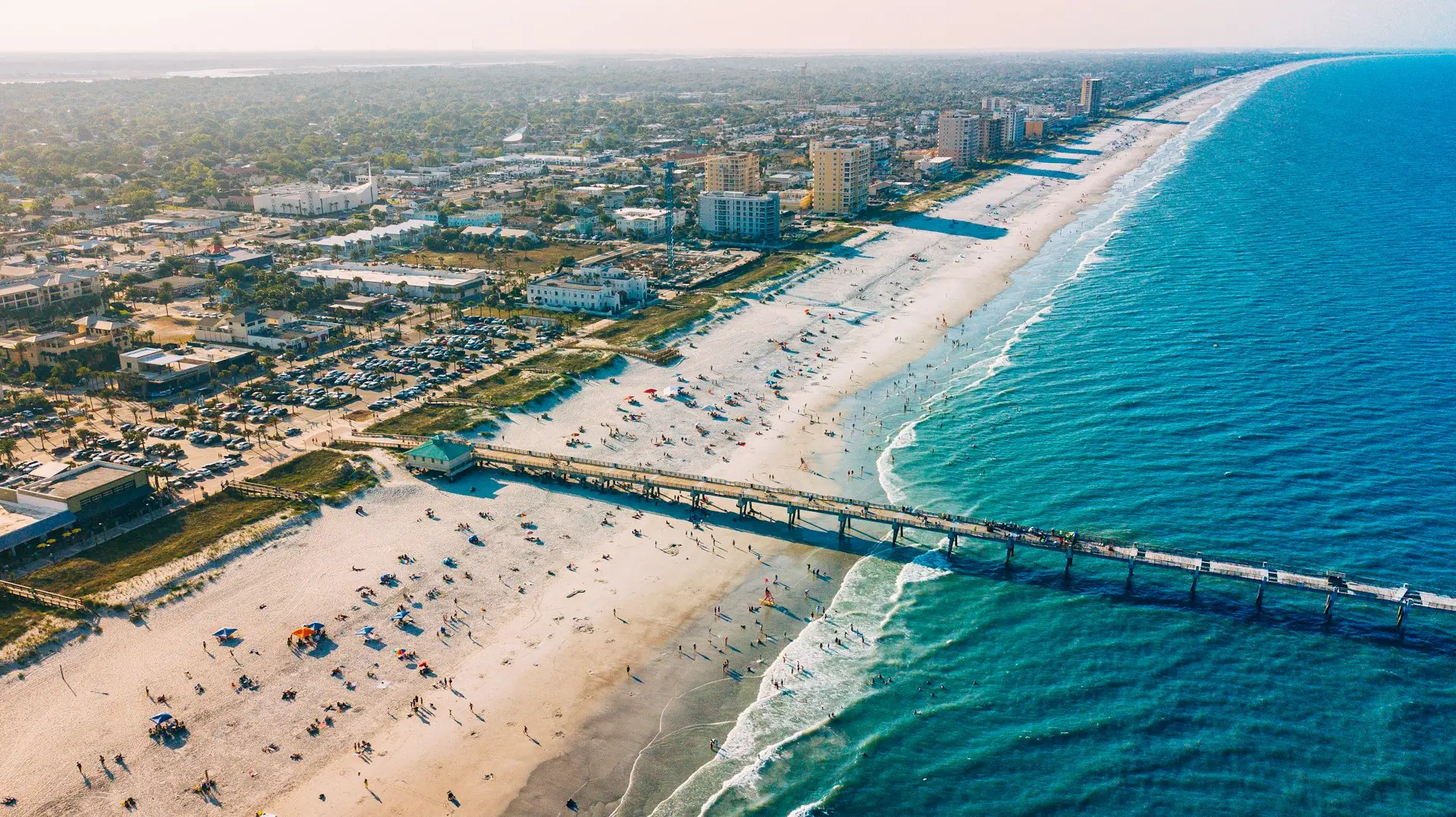 Aerial view of a Northeast Florida beach with pier — representing the St. Augustine and Jacksonville coastal service area